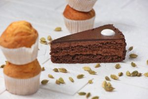 A Slice of Chocolate Cake and Scattered Cardamom