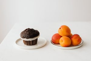 Fresh ripe apricots served on table with chocolate muffin