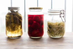 three jars filled with different types of food