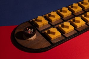 a wooden tray filled with pieces of cheese